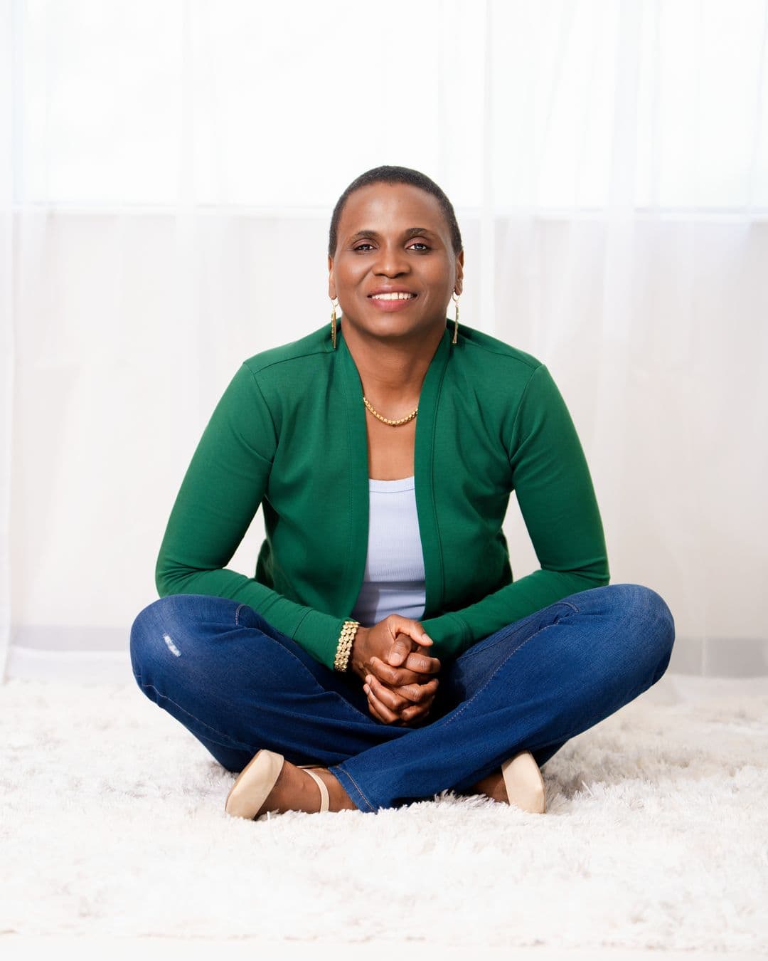 Peace Stivers, author of When God Speaks in Dreams, seated calmly in a green cardigan.